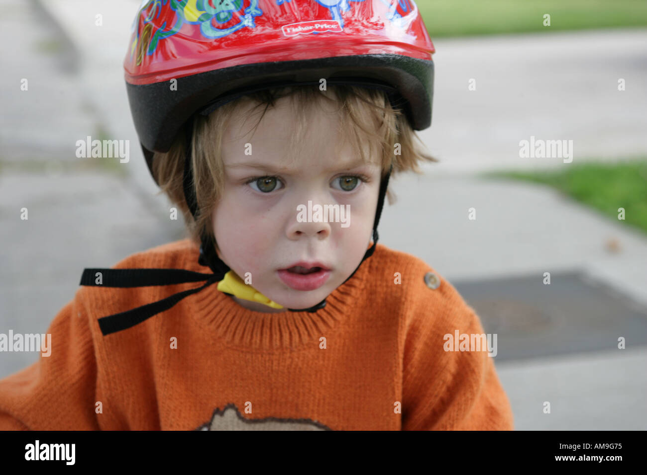 closeup of three year old boy on bike with helmet Stock Photo Alamy