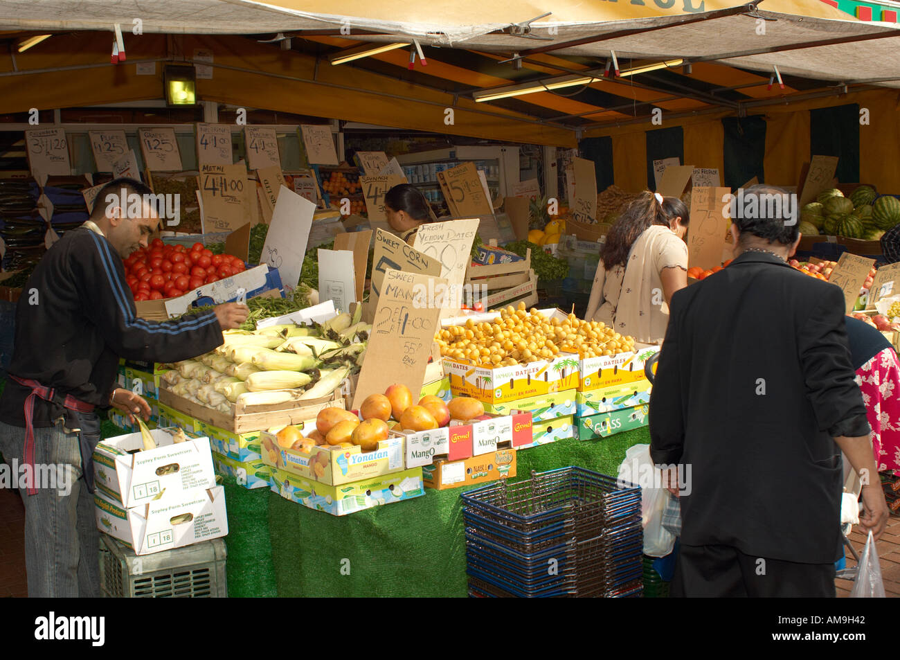 Market stall selling fruit and veg at Green Street East London UK Stock