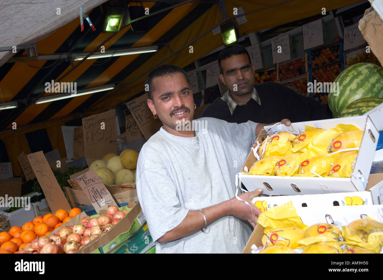 Market stall selling fruit and veg at Green Street East London UK Stock