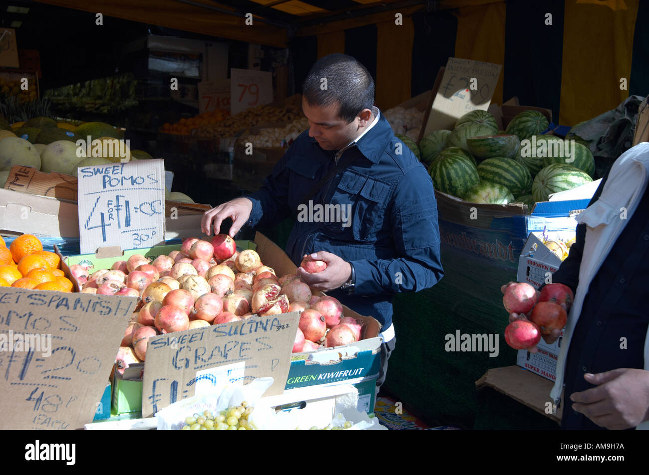 Market stall selling fruit and veg at Green Street East London UK Stock