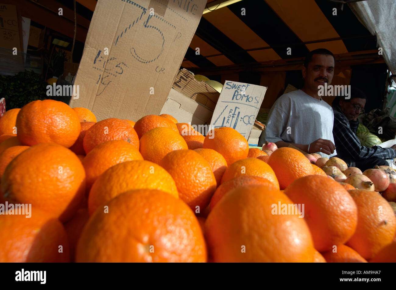 Market stall selling fruit and veg at Green Street East London UK Stock