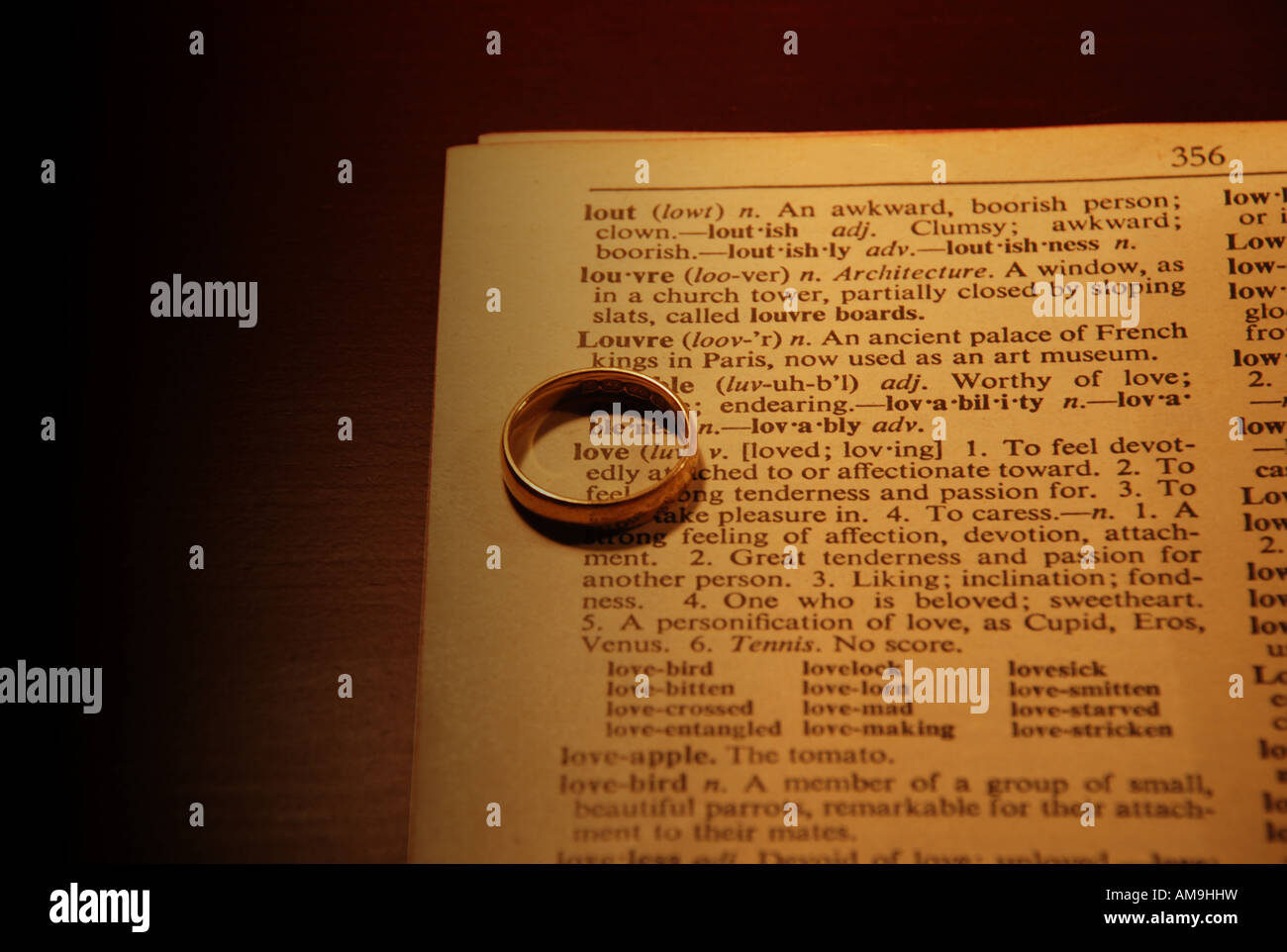 Love circled with a ring in a dictionary book Stock Photo