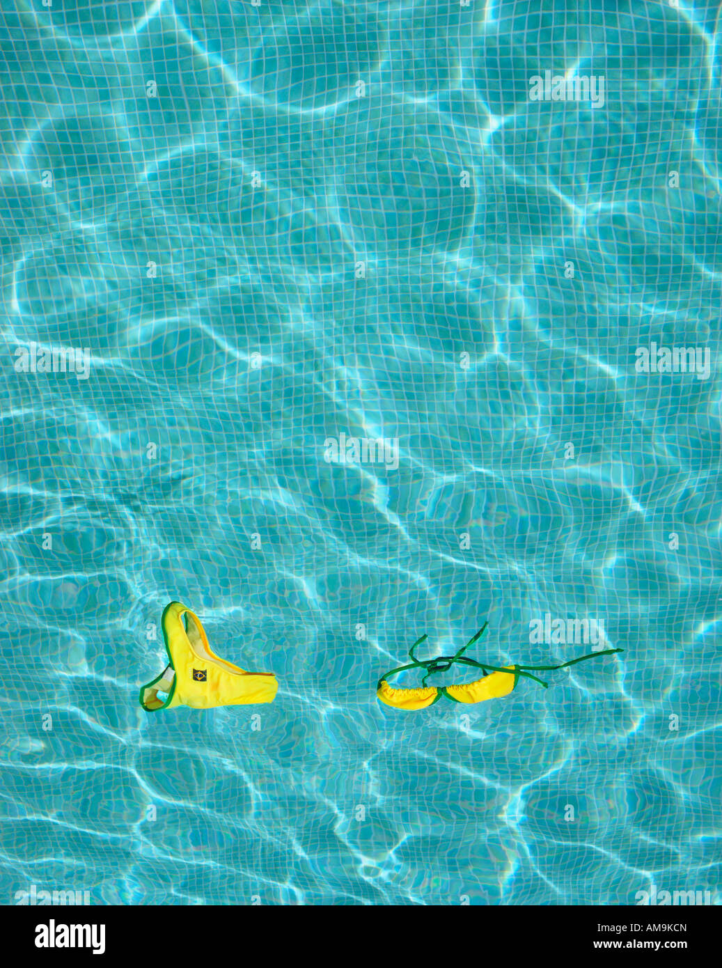 Bikini floating in empty pool. Stock Photo