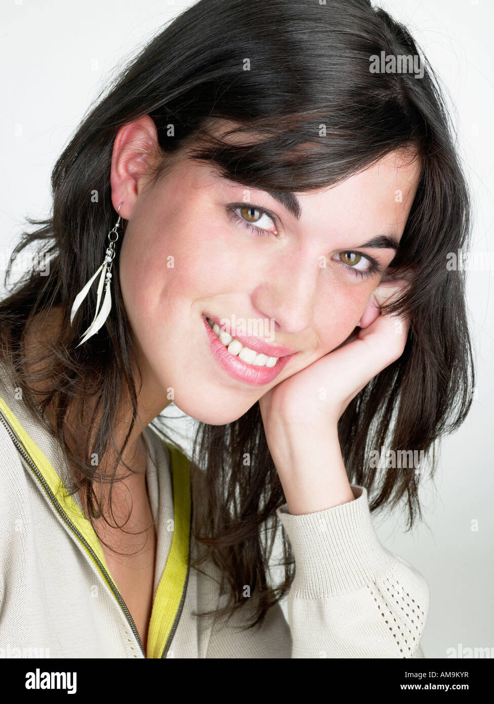 Woman smiling resting head on hand. Stock Photo