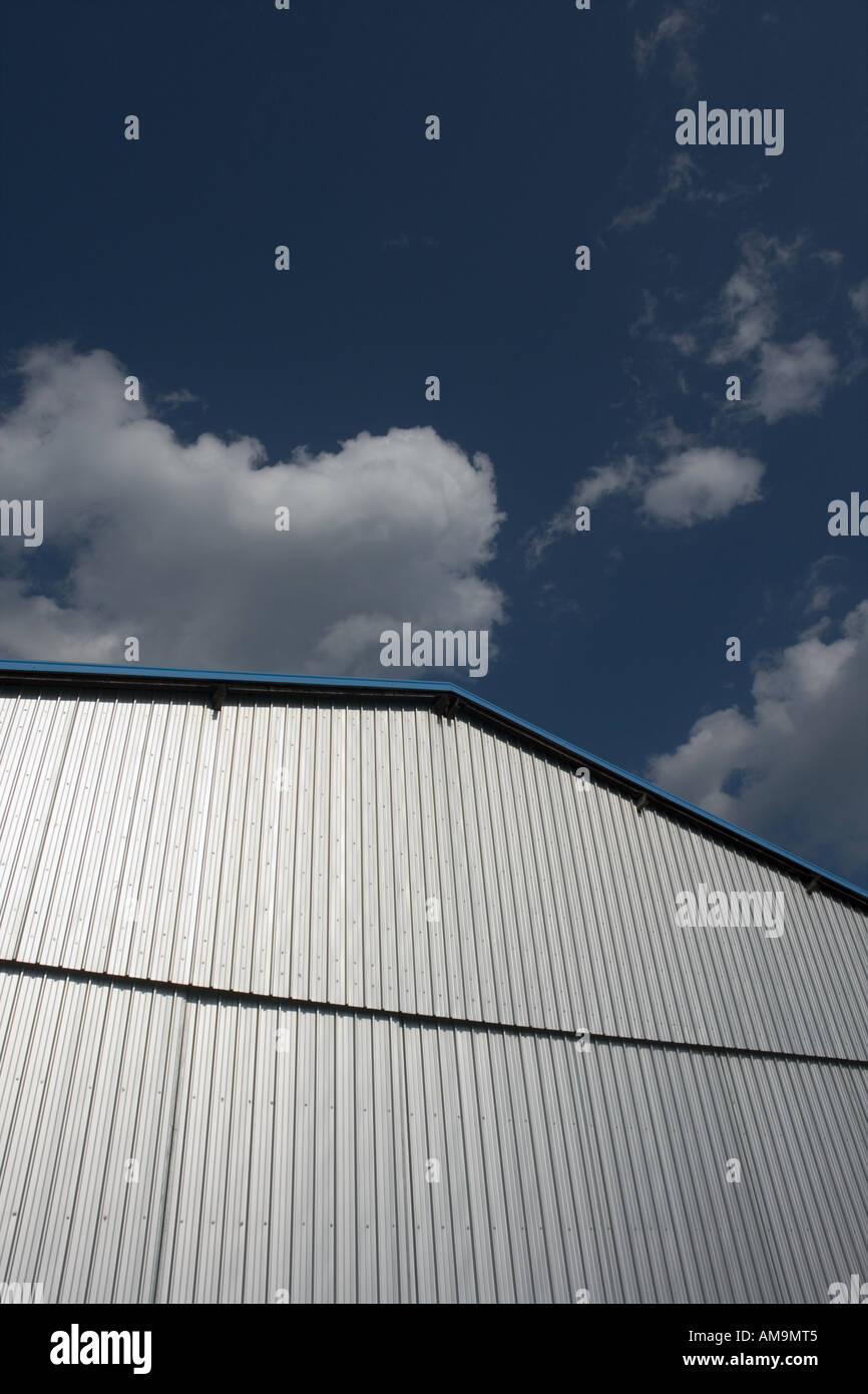 Closed airport hangar doors against cloudy blue sky Stock Photo