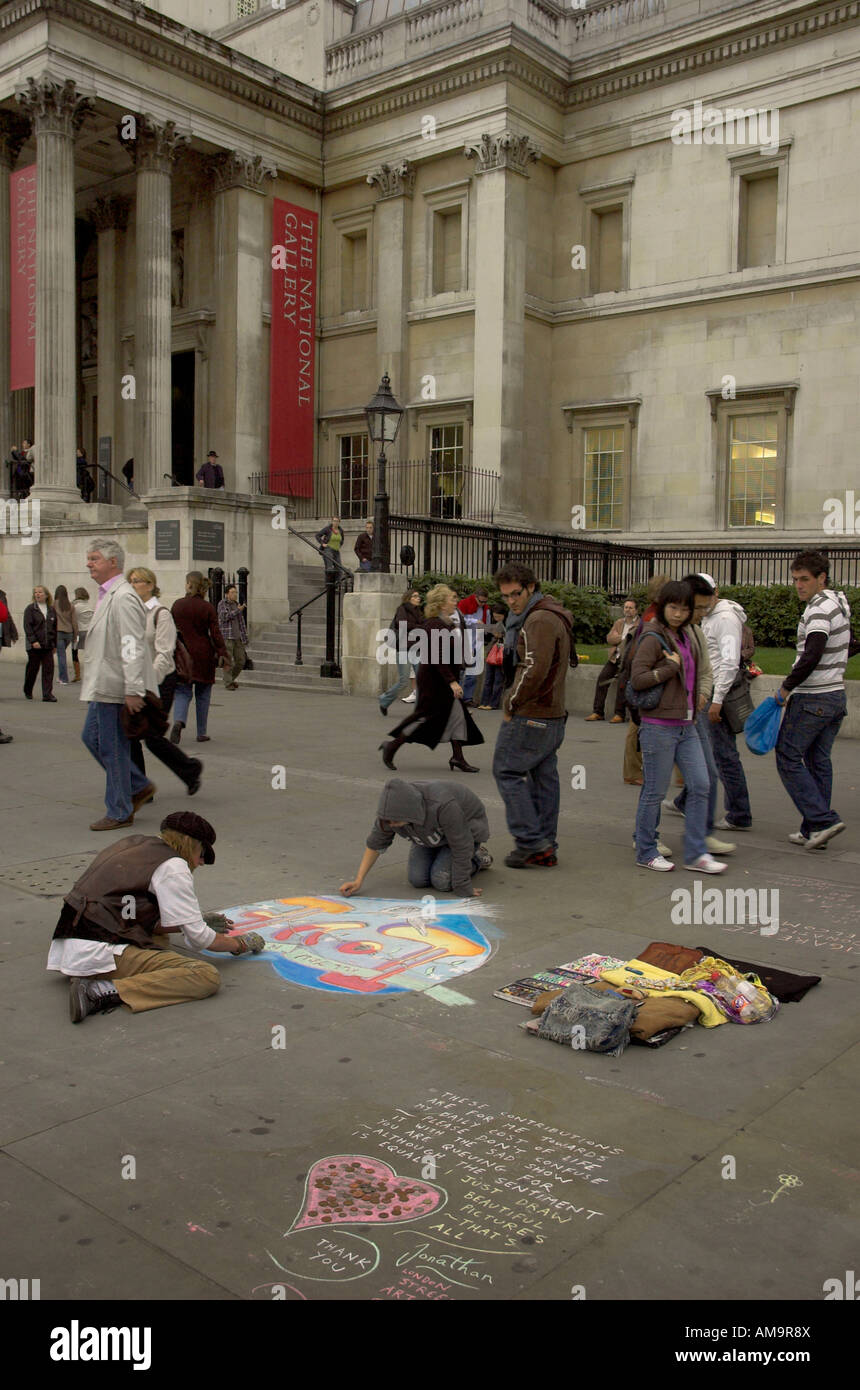 Two street artists drawing in chalk on the pavement in Trafalgar Square Stock Photo