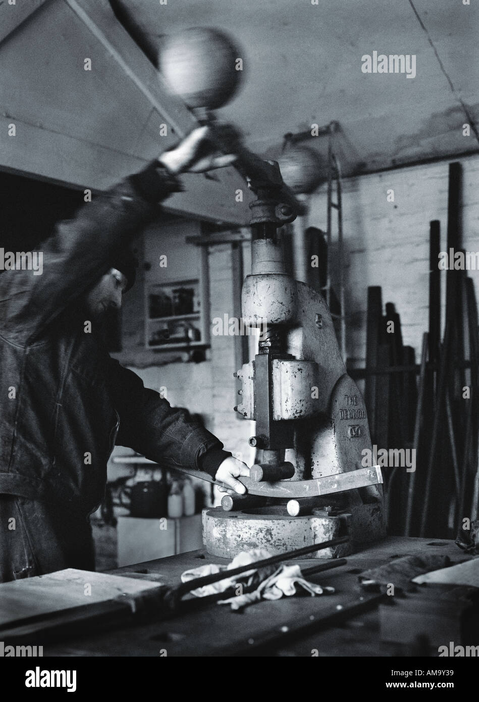 man using a machine press photographed in Black and white Stock Photo