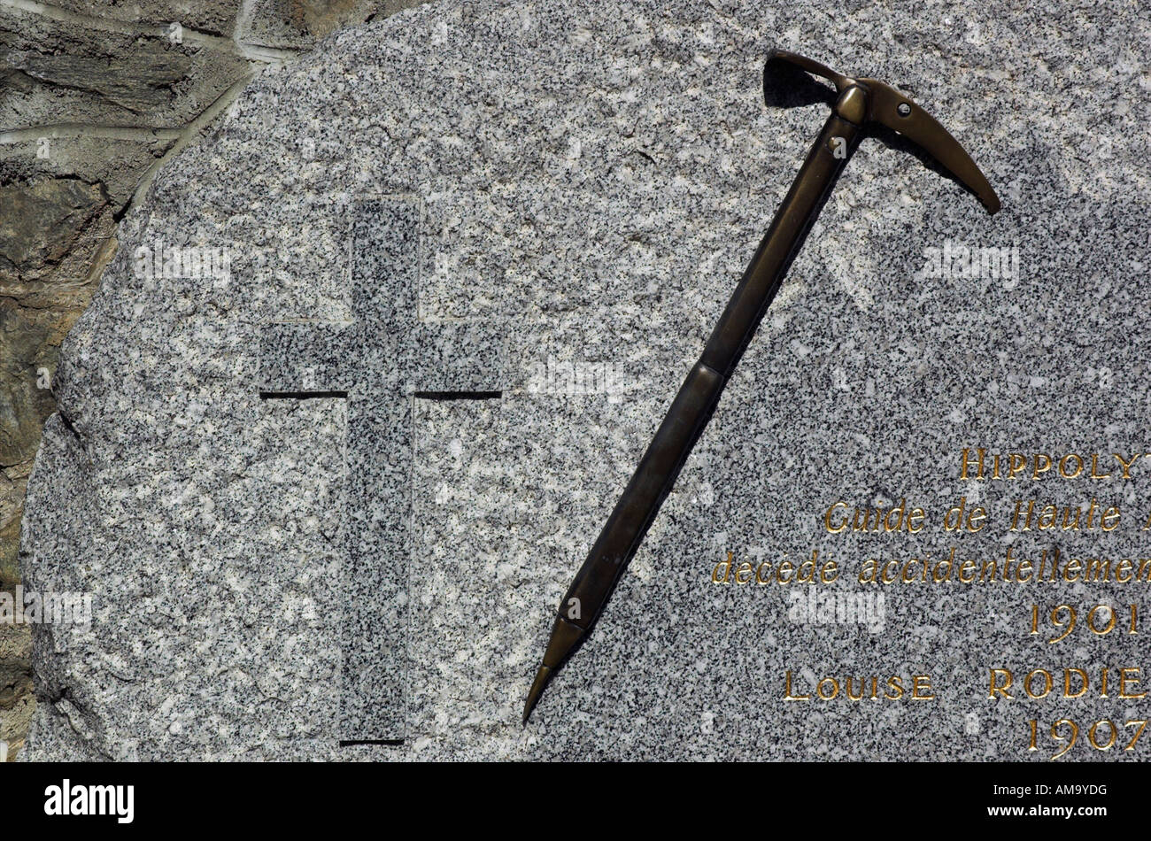 A grave decorated with the deceased climbers ice axe in a graveyard in the French Alps Stock