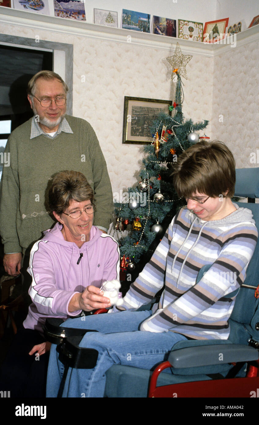 mother father teenage daughter cerebral palsy at Christmas  Stock Photo