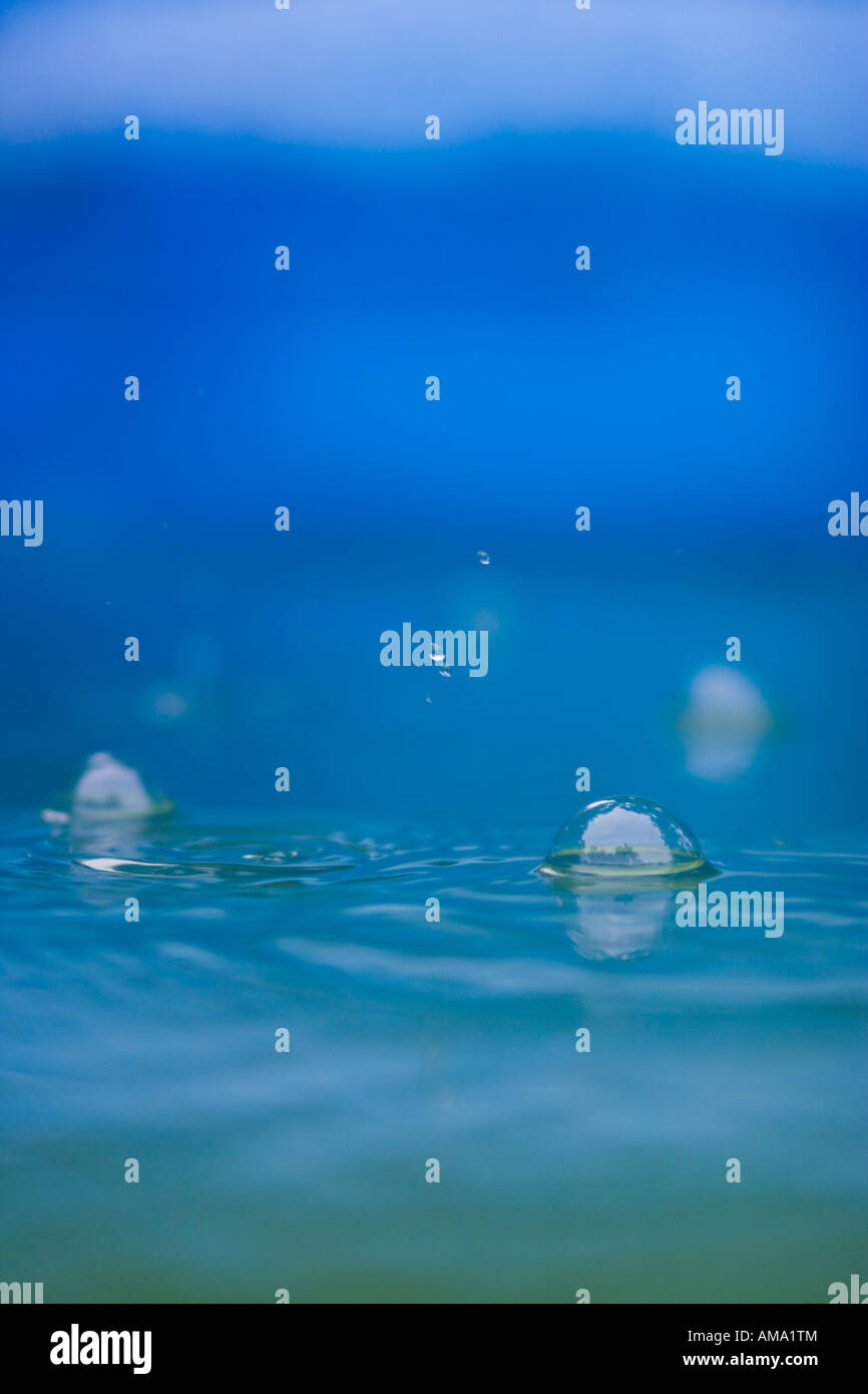 Rain falling in the swimming pool causing bubbles Stock Photo Alamy