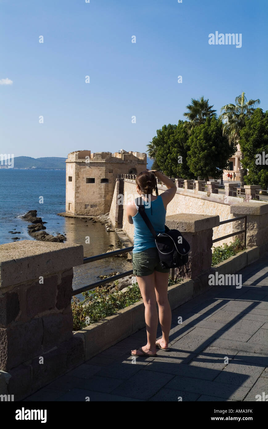 dh Bastioni Cristoforo Colombo ALGHERO SARDINIA Girl photographing taking pictures tourist camera woman with holiday photos photographs teenage walls Stock Photo