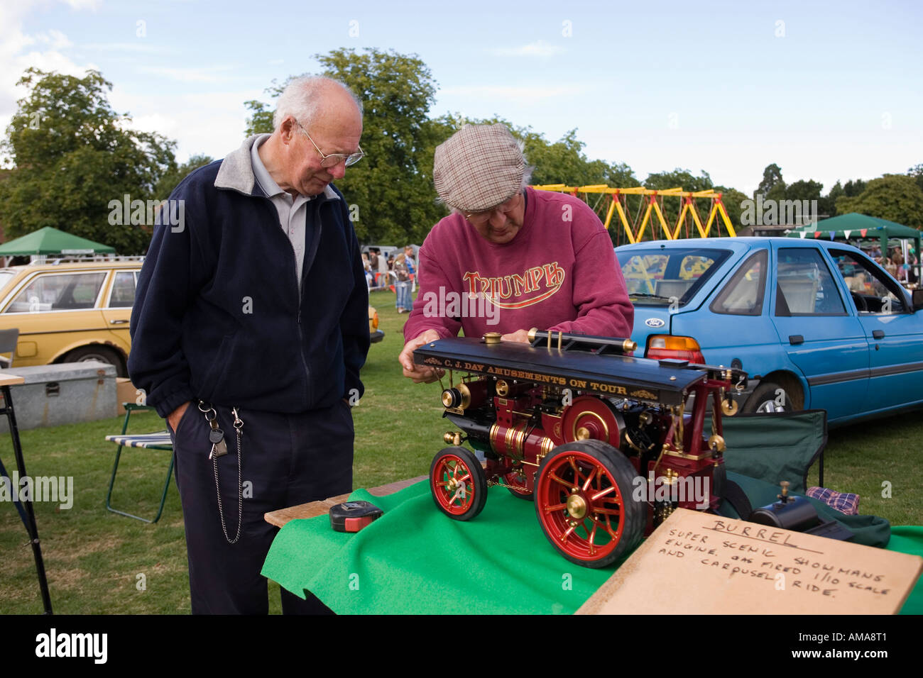 West Sussex Wisborough Green Village Fair on the Green men looking at model Burrel traction engine Stock Photo