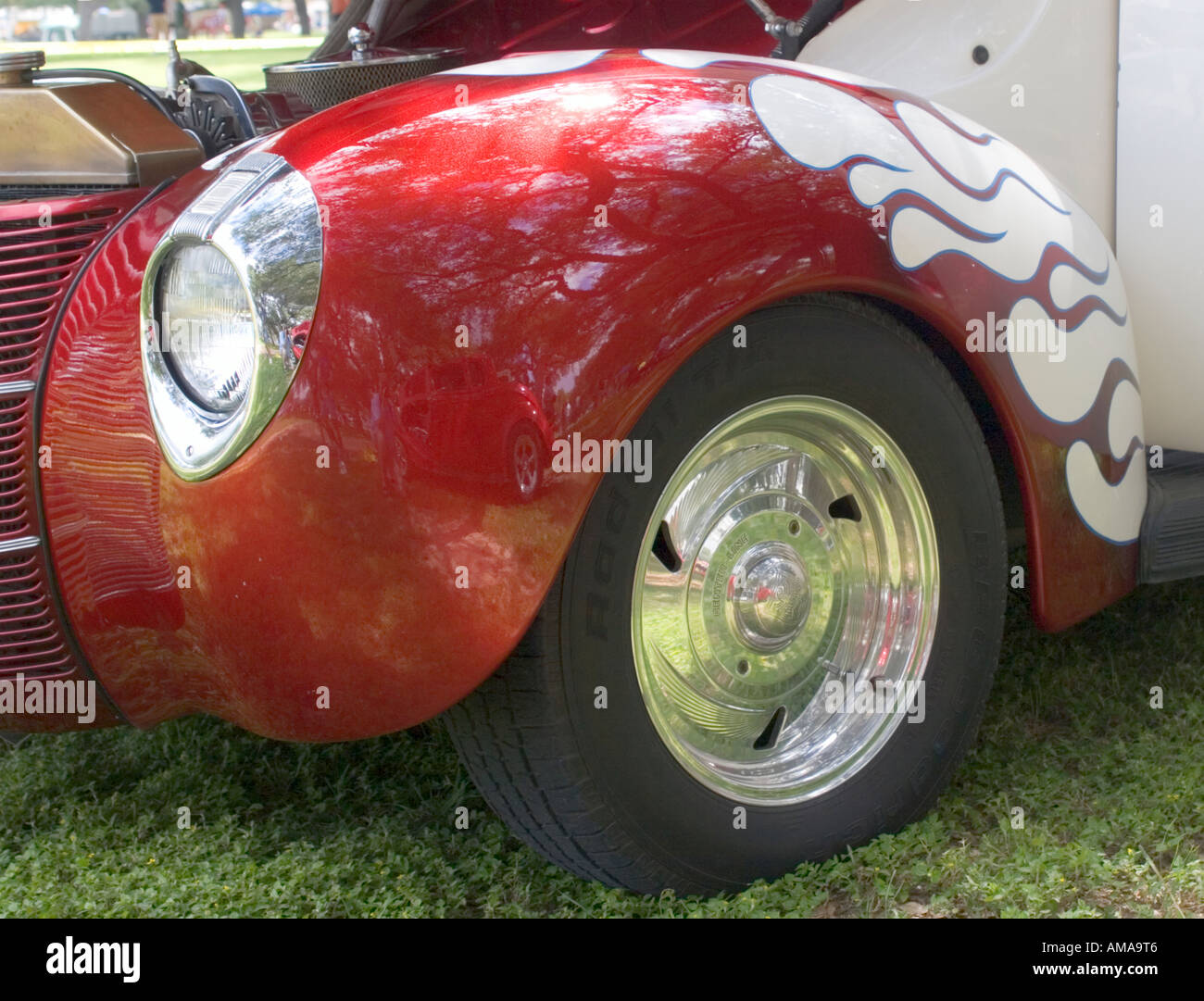 Red flames over pearl white paint job on front fender of custom 1940