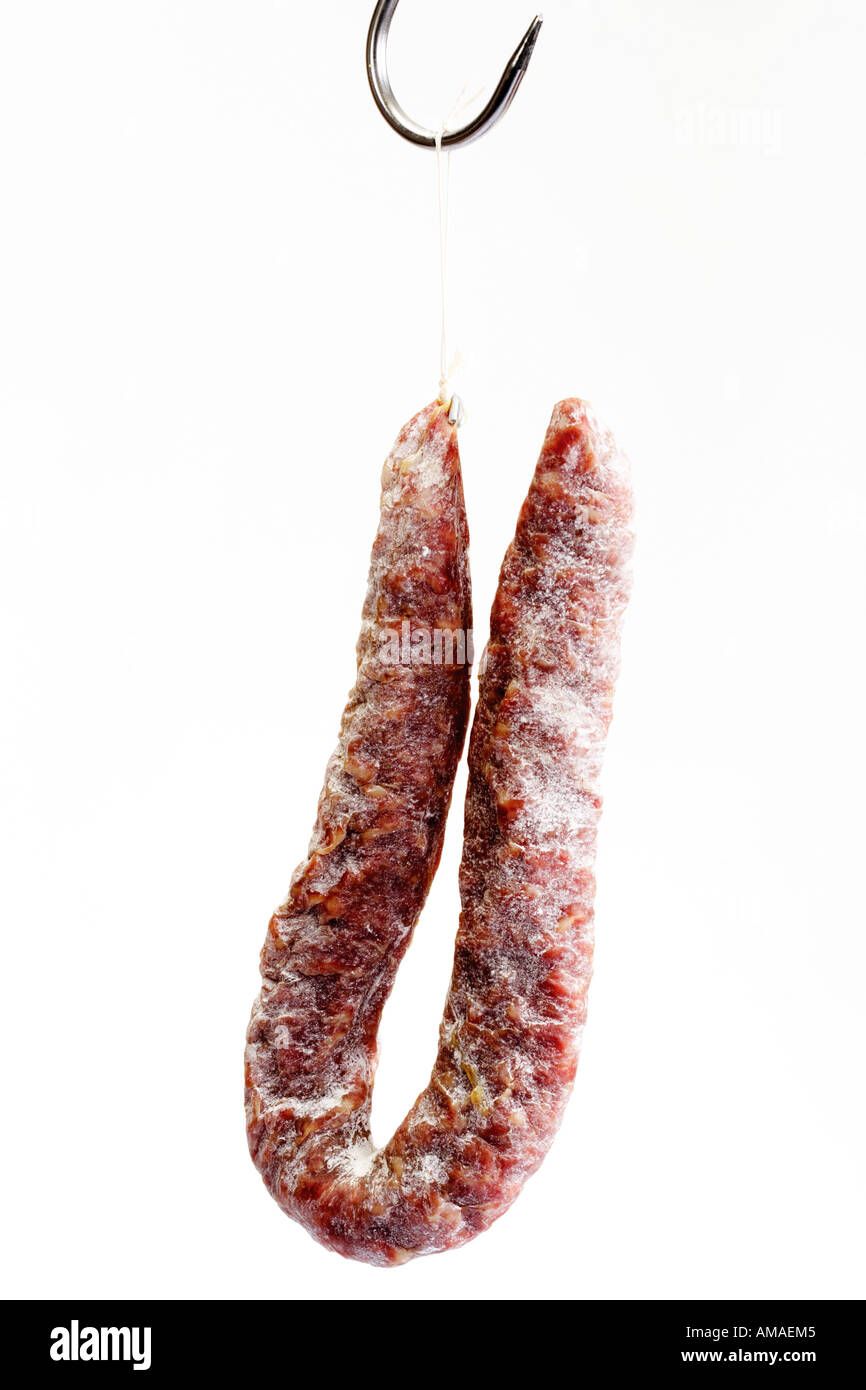 Salami hanging on butcher hook, closeup Stock Photo Alamy