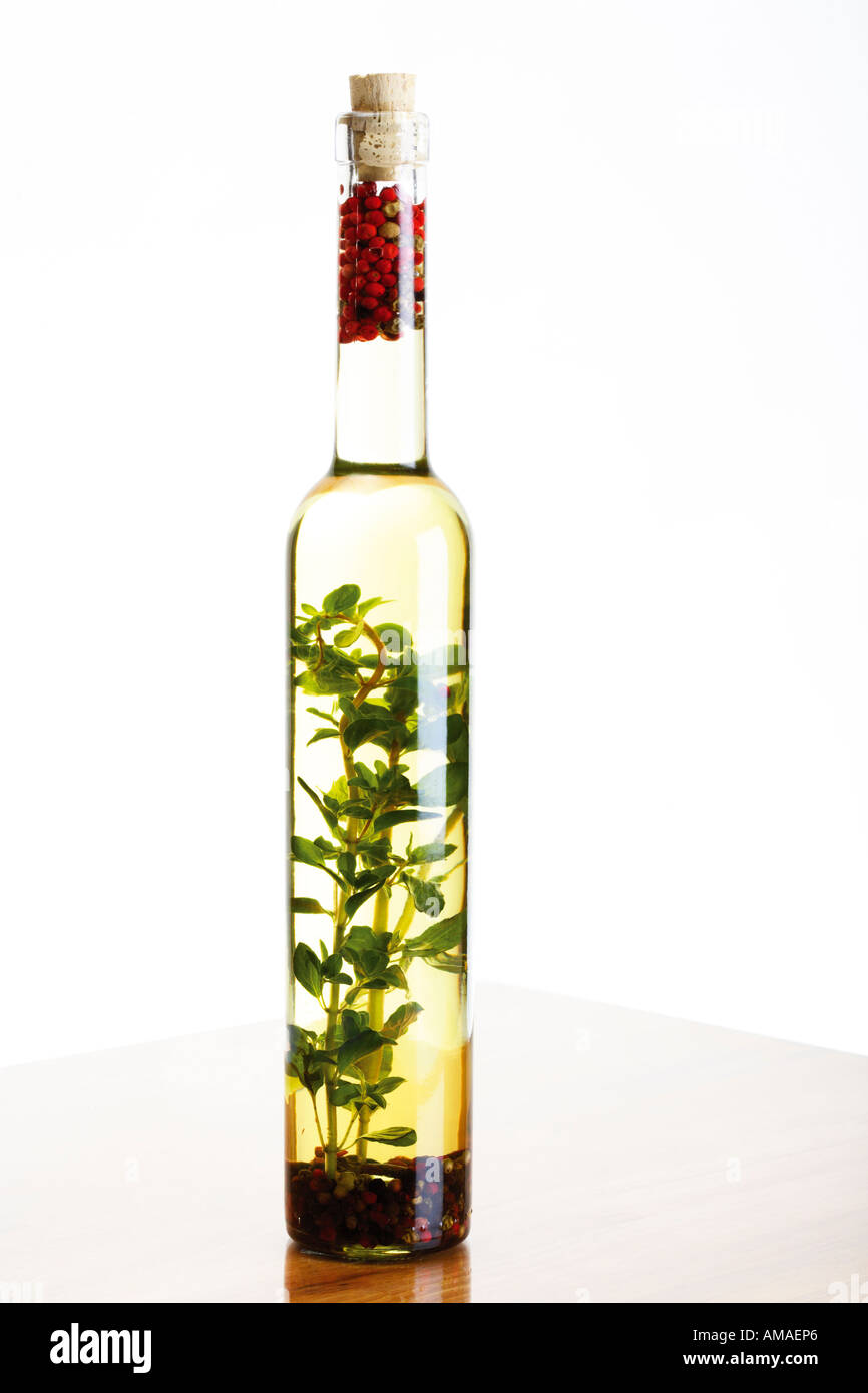 Bottle of olive oil with herbs and spices, close-up Stock Photo - Alamy