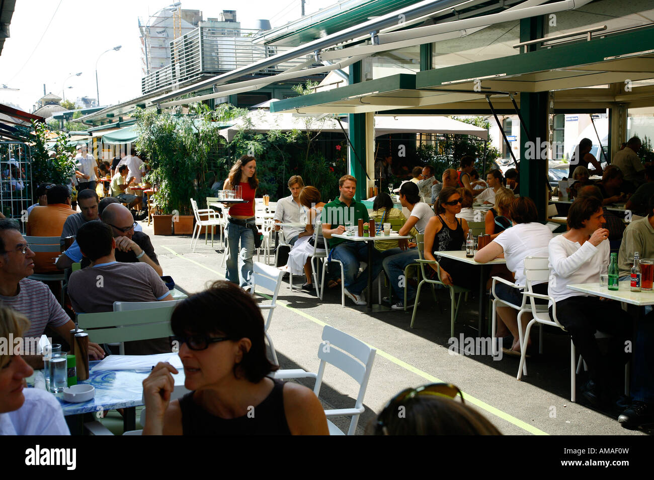 Aug 2008 - People sitting at an outdoors restaurant in the Naschmarkt Vienna Austria Stock Photo
