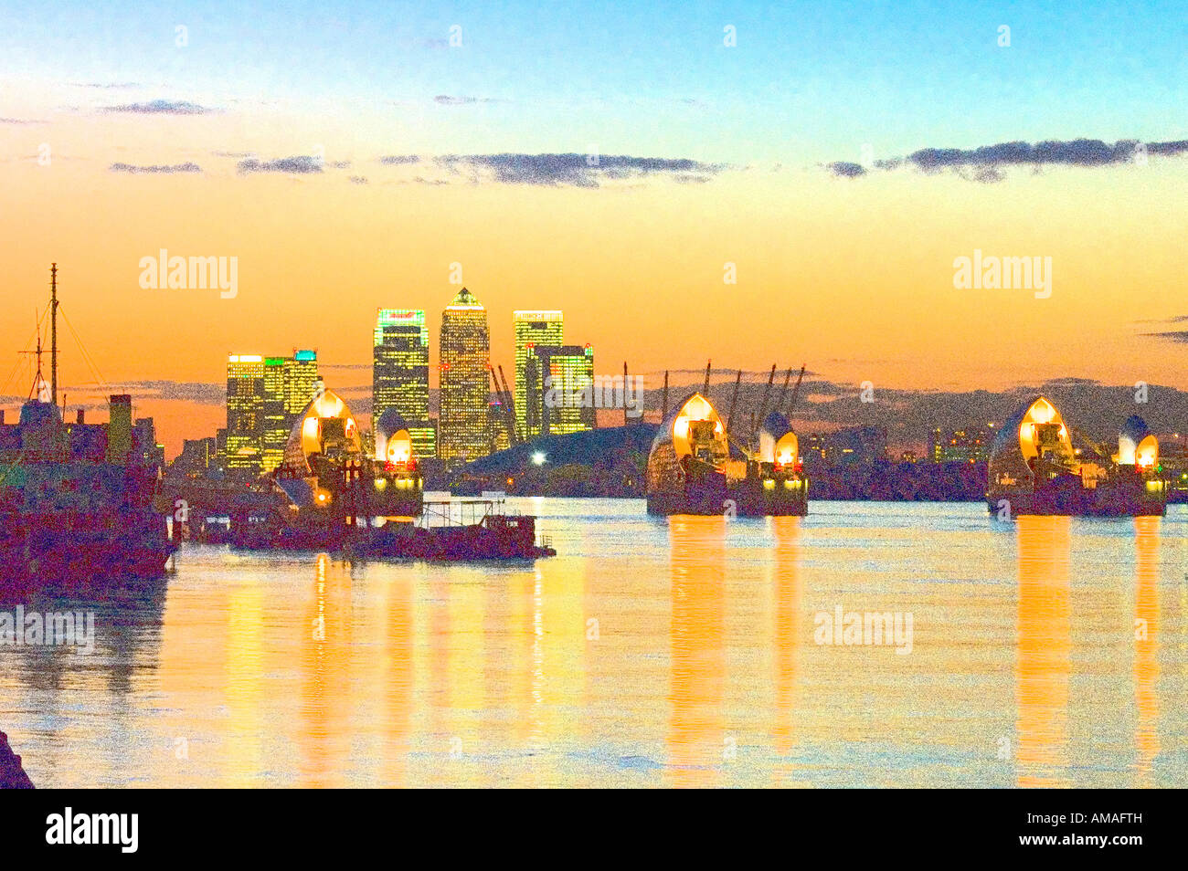 thames barrier at sunset dusk evening with river thames and canary ...
