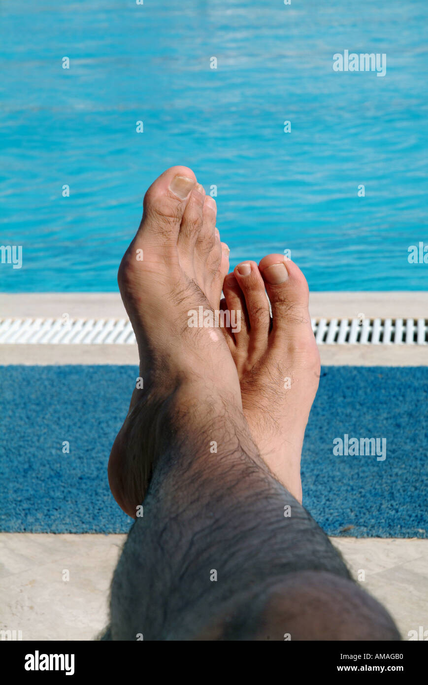 FEET IN THE POOL SIDE Stock Photo - Alamy