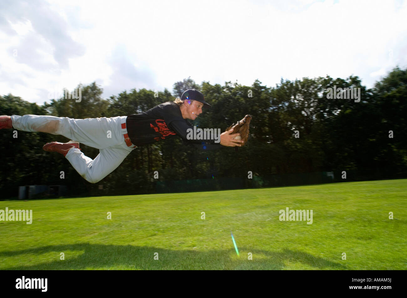 A baseball player diving to catch the ball Stock Photo Alamy