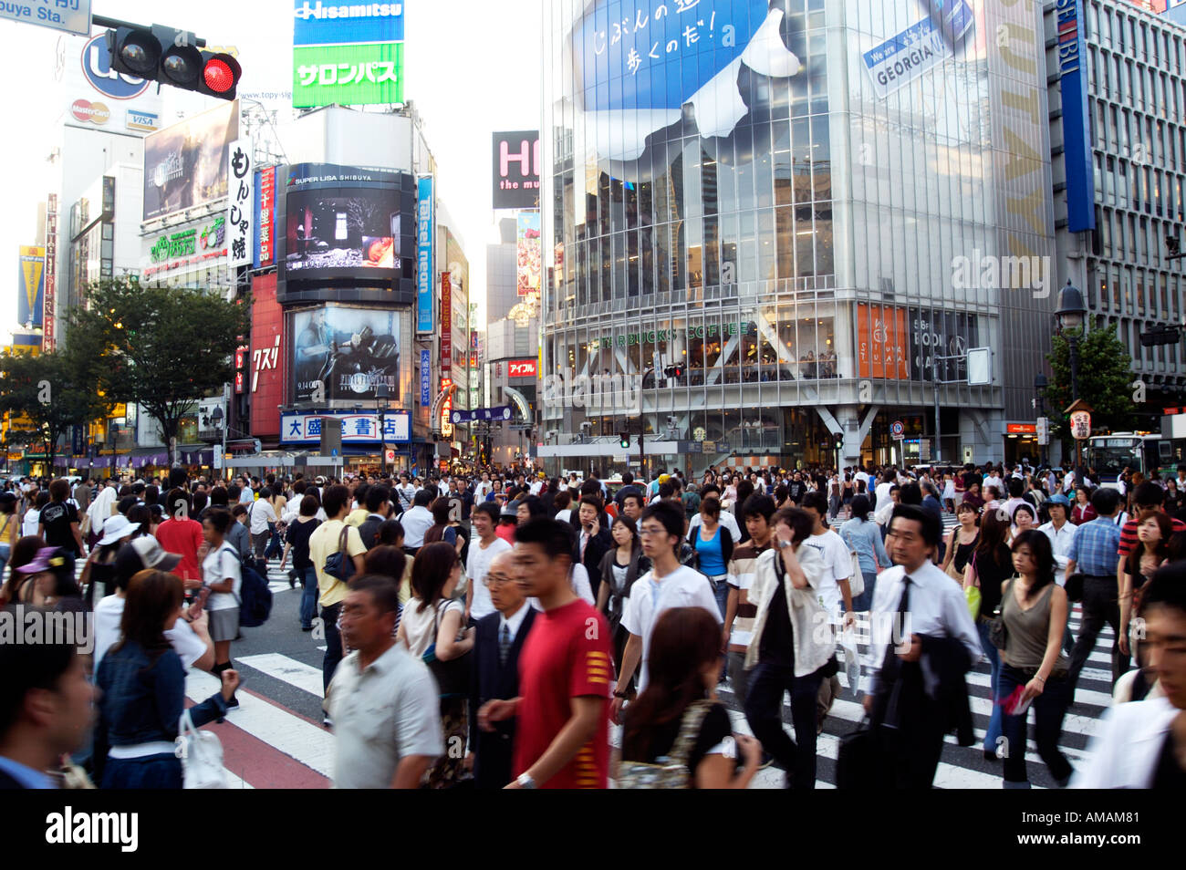 Crowds of people crossing street at Hachiko crossing in Shibuya Tokyo Japan Stock Photo