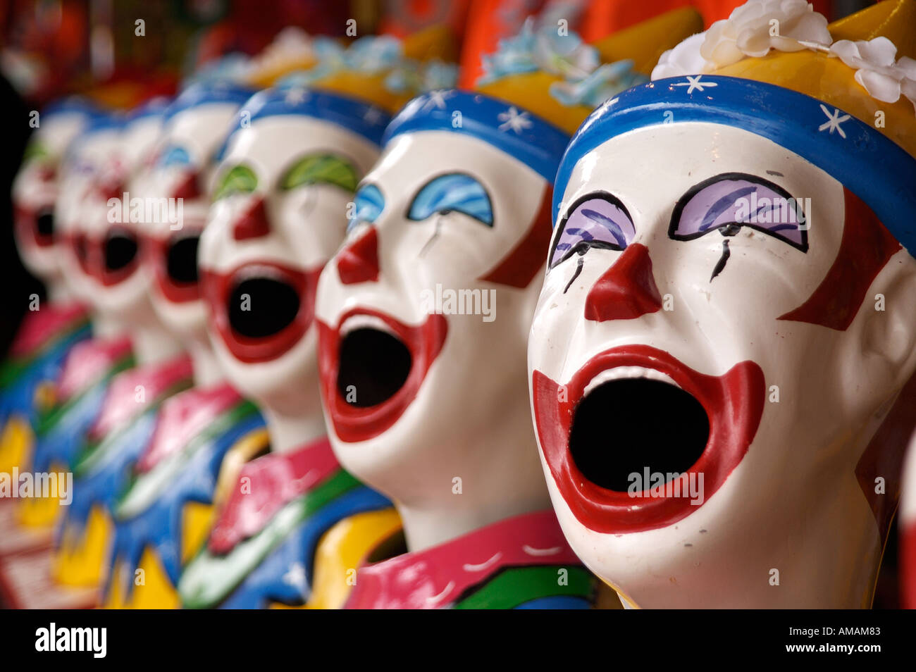 Row of Clowns heads on ball game at funfair in Royal melbourne Show