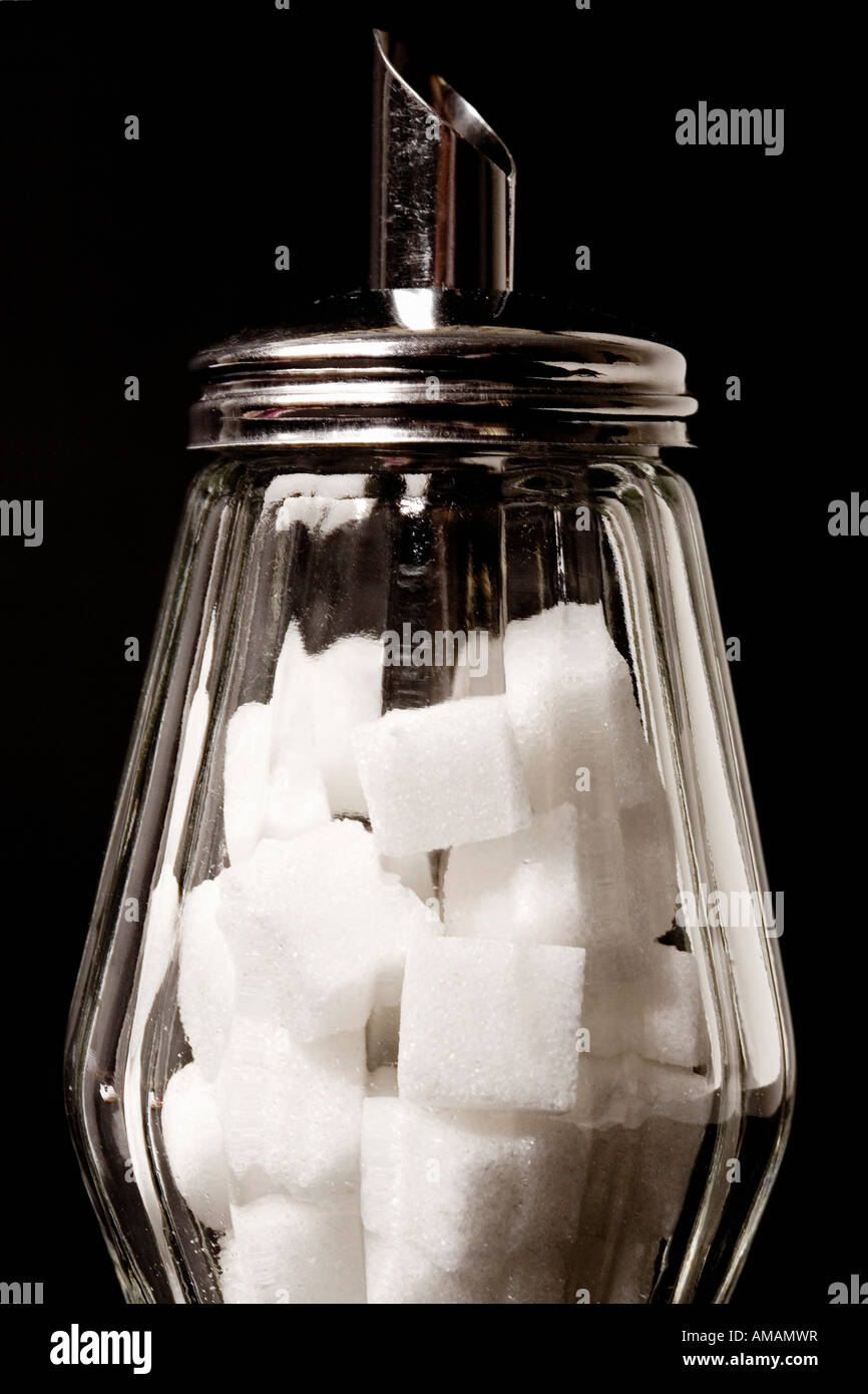 A sugar dispenser filled with sugar cubes Stock Photo