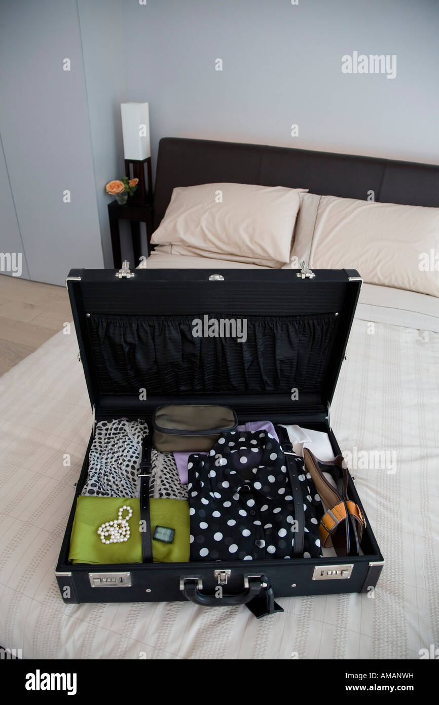 An open suitcase on a bed Stock Photo