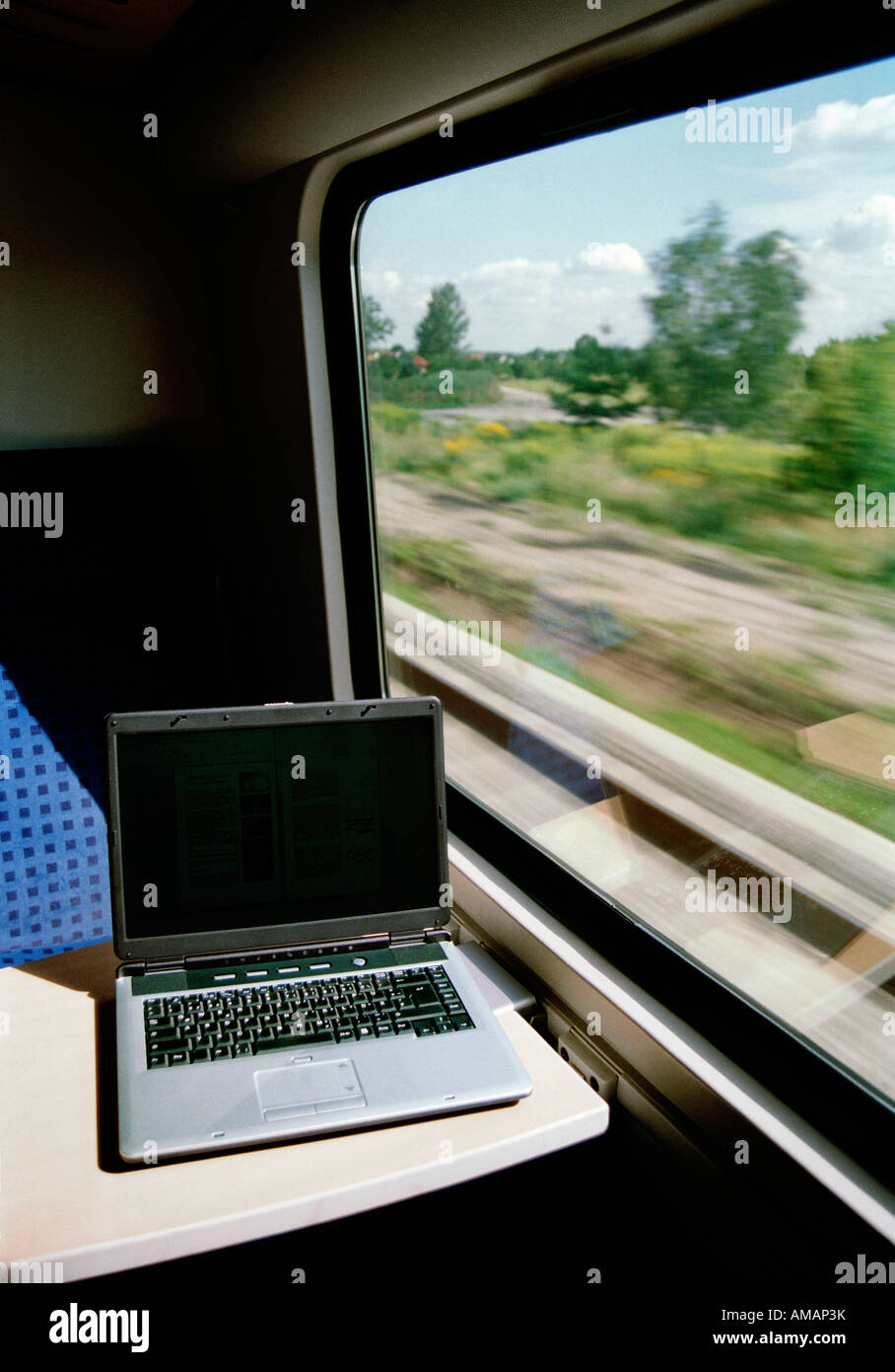 A laptop on a table in a train carriage Stock Photo Alamy