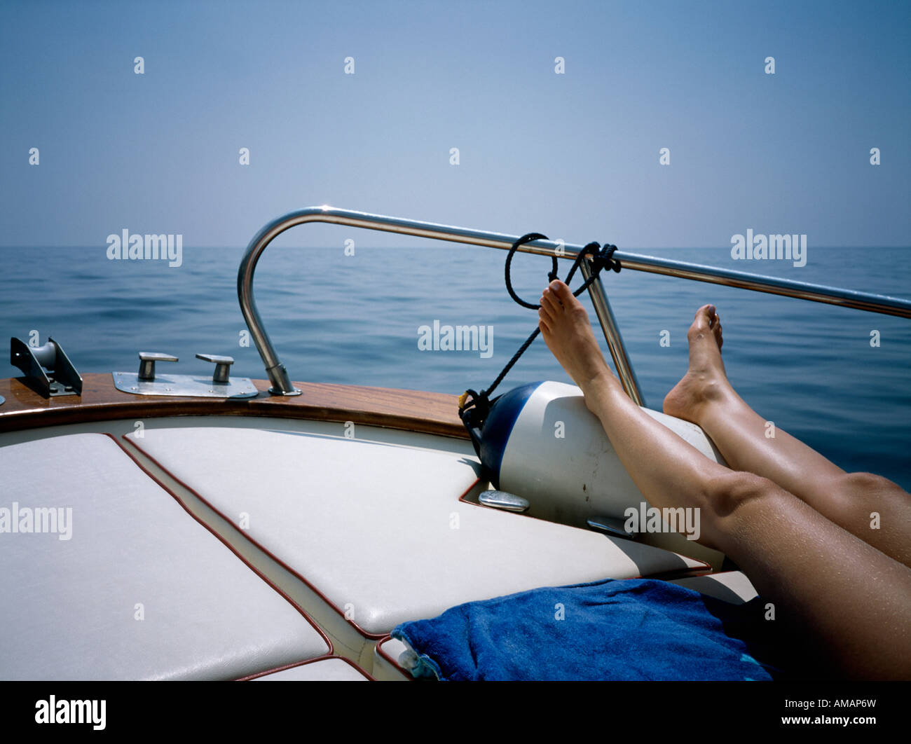 A woman sunbathing on a boat deck Stock Photo - Alamy