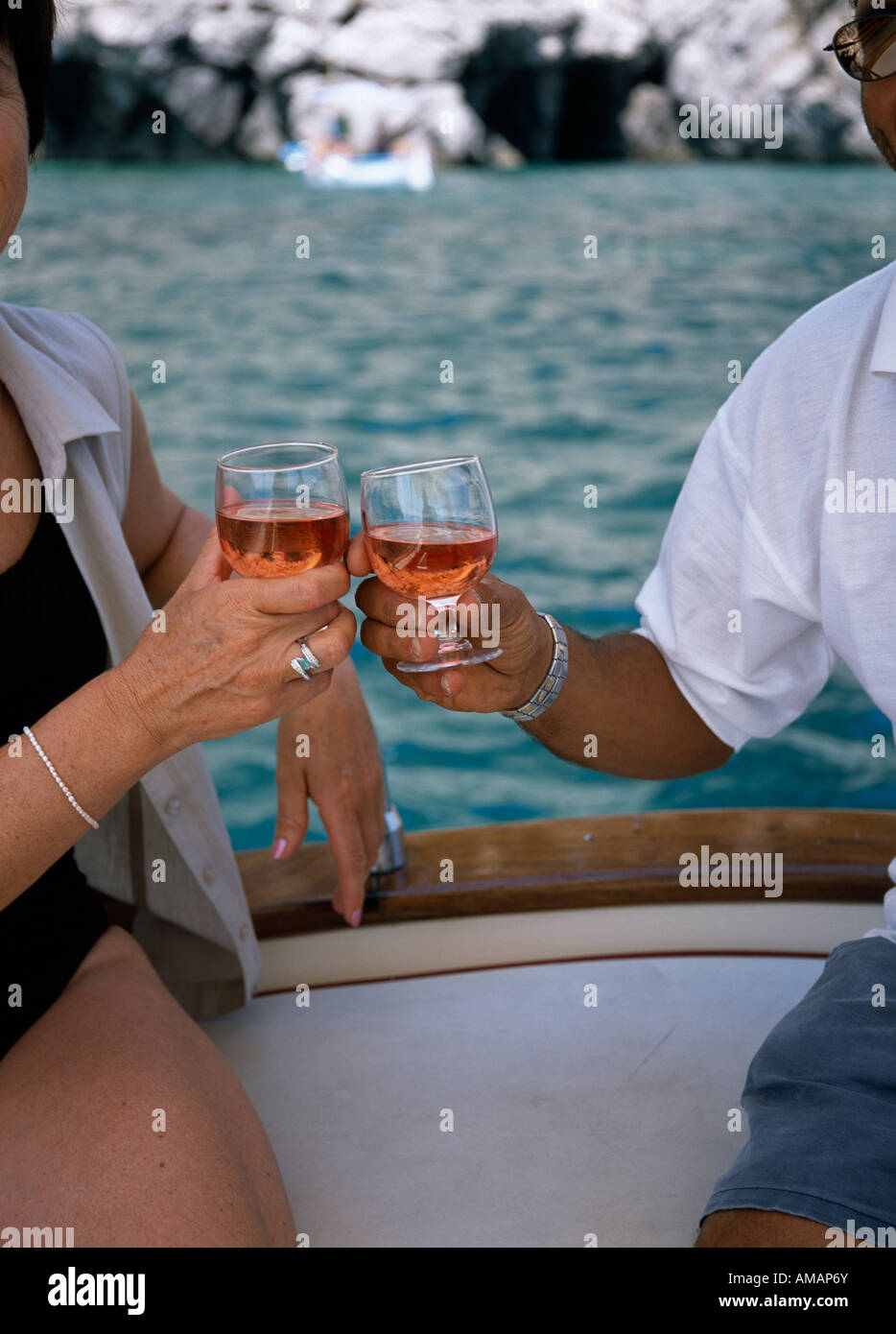 A couple toasting on a boat with glasses of rose wine Stock Photo Alamy