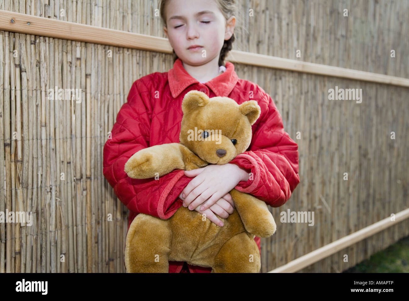 A young girl holding a teddy bear Stock Photo