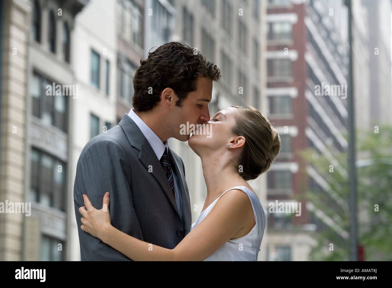 A bride and groom kissing in the street Stock Photo - Alamy