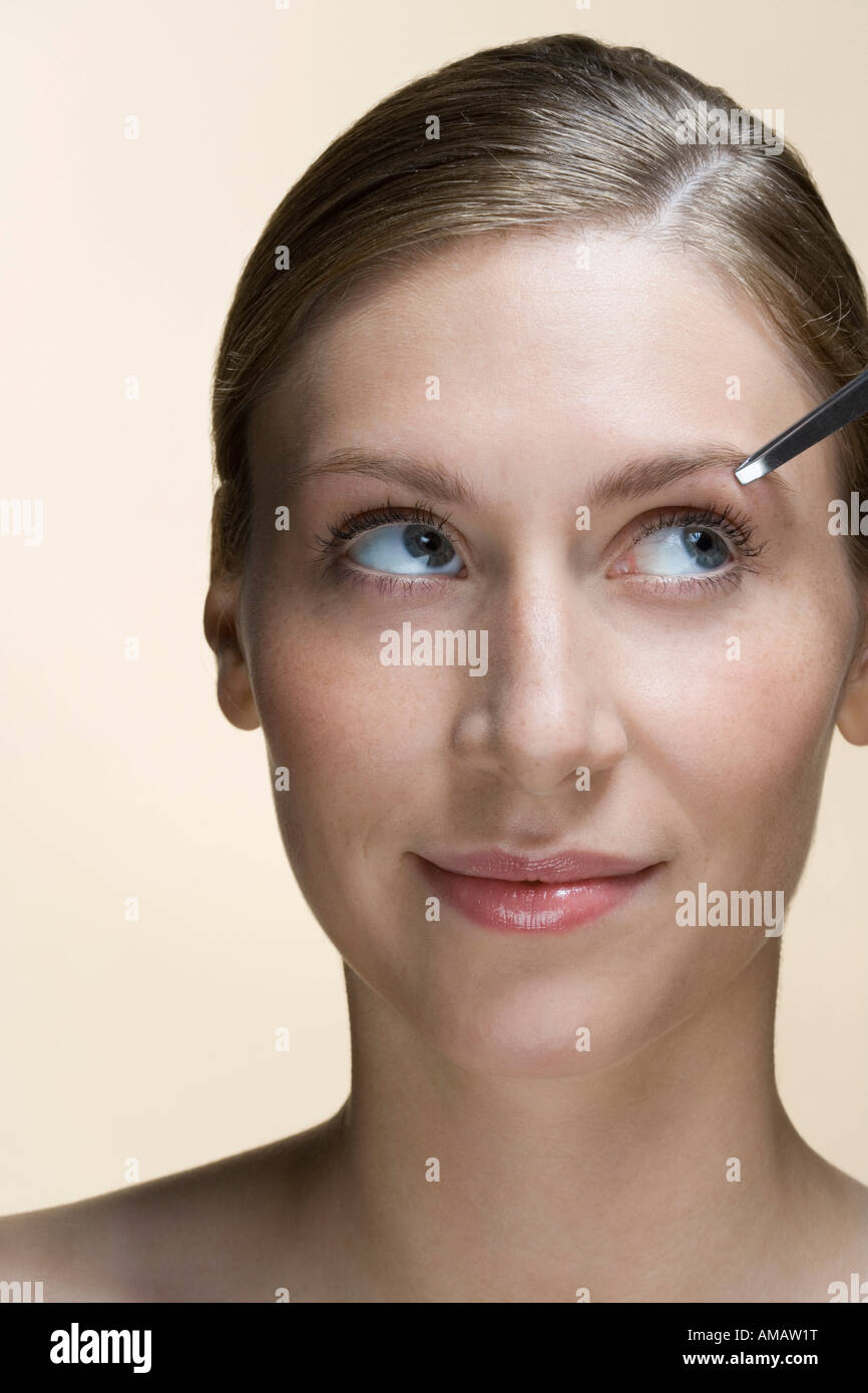 A woman having her eyebrows plucked Stock Photo Alamy