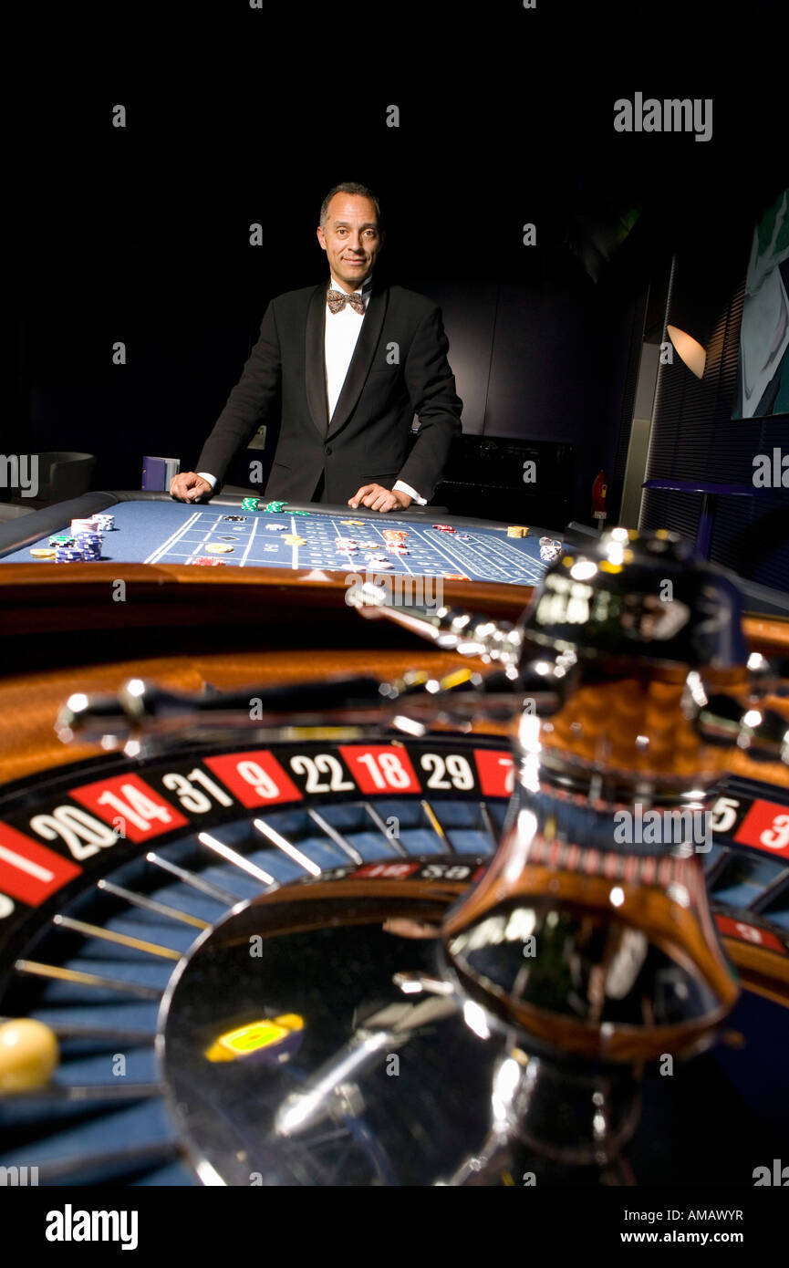 Well dressed man playing roulette in casino Stock Photo