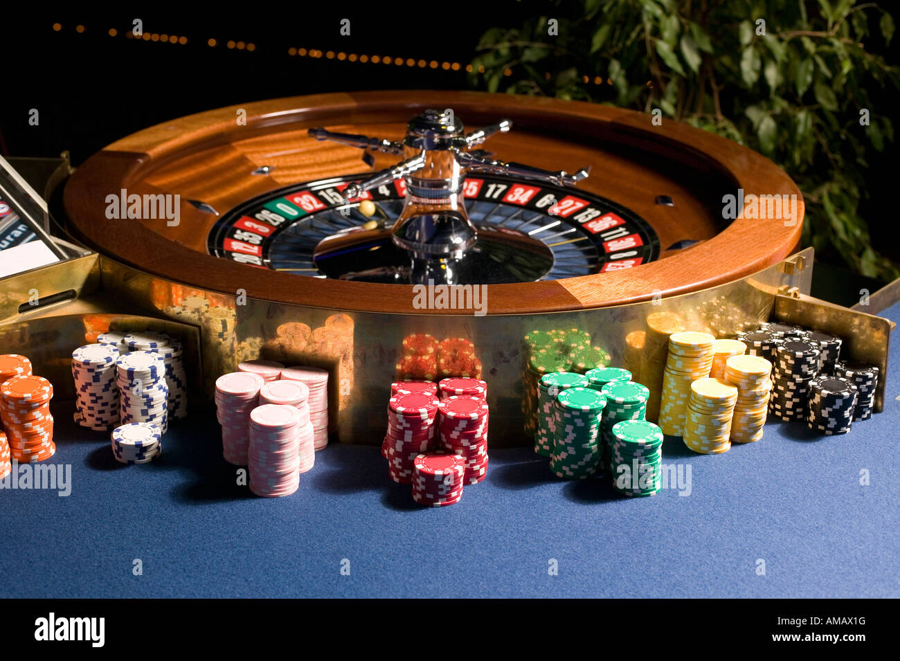 Roulette wheel with multiple stacks of gambling chips Stock Photo Alamy