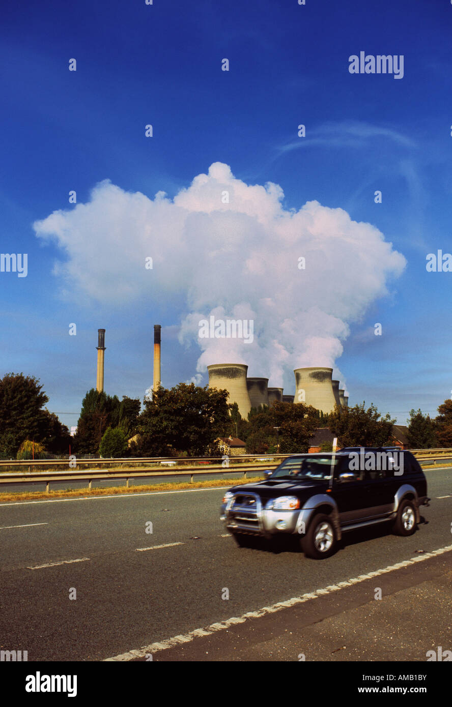 four by four vehicle driving past ferrybridge power station yorkshire uk Stock Photo