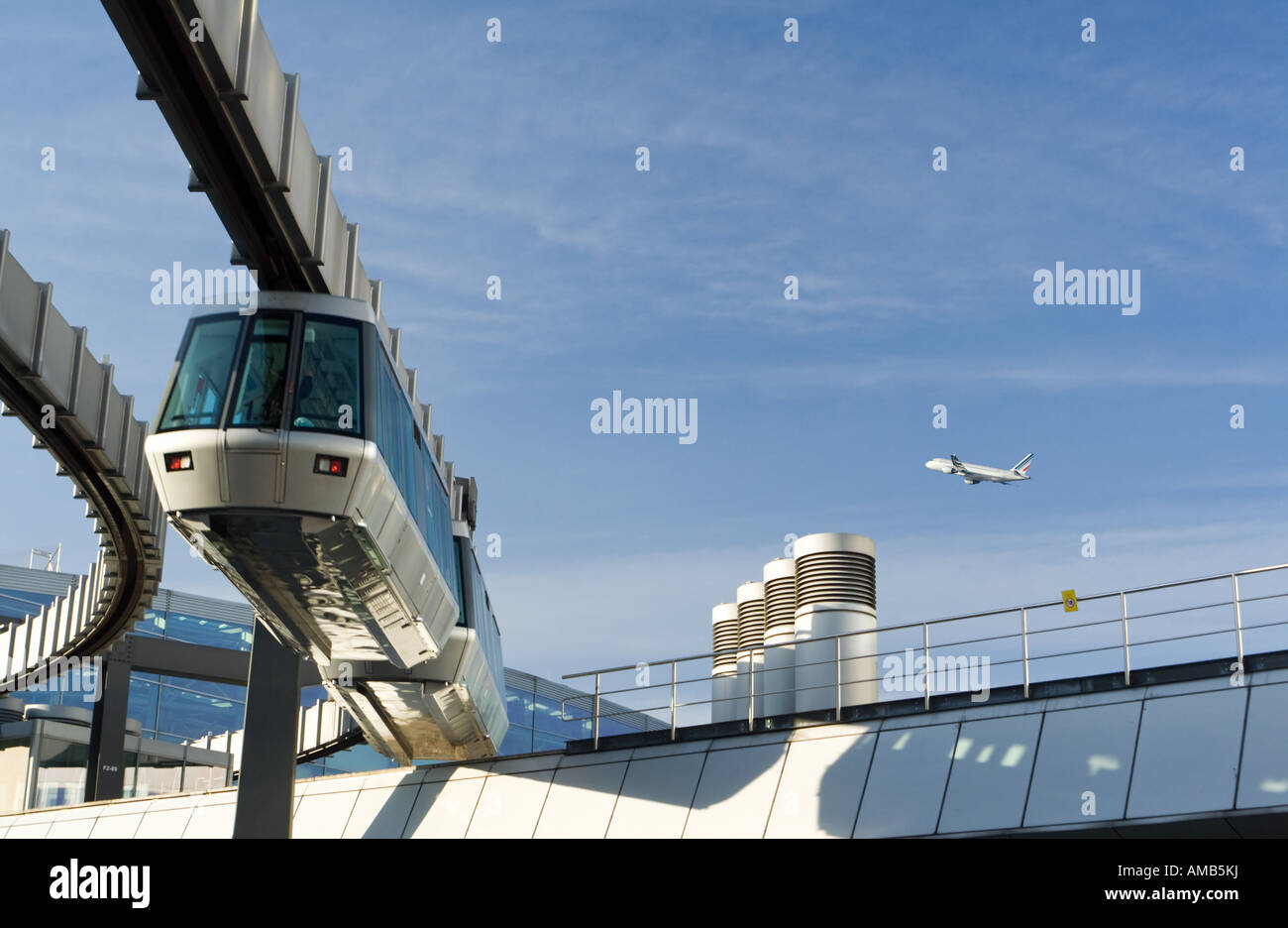 monorail at DUS airport, blue sky with airplane taking off Stock Photo