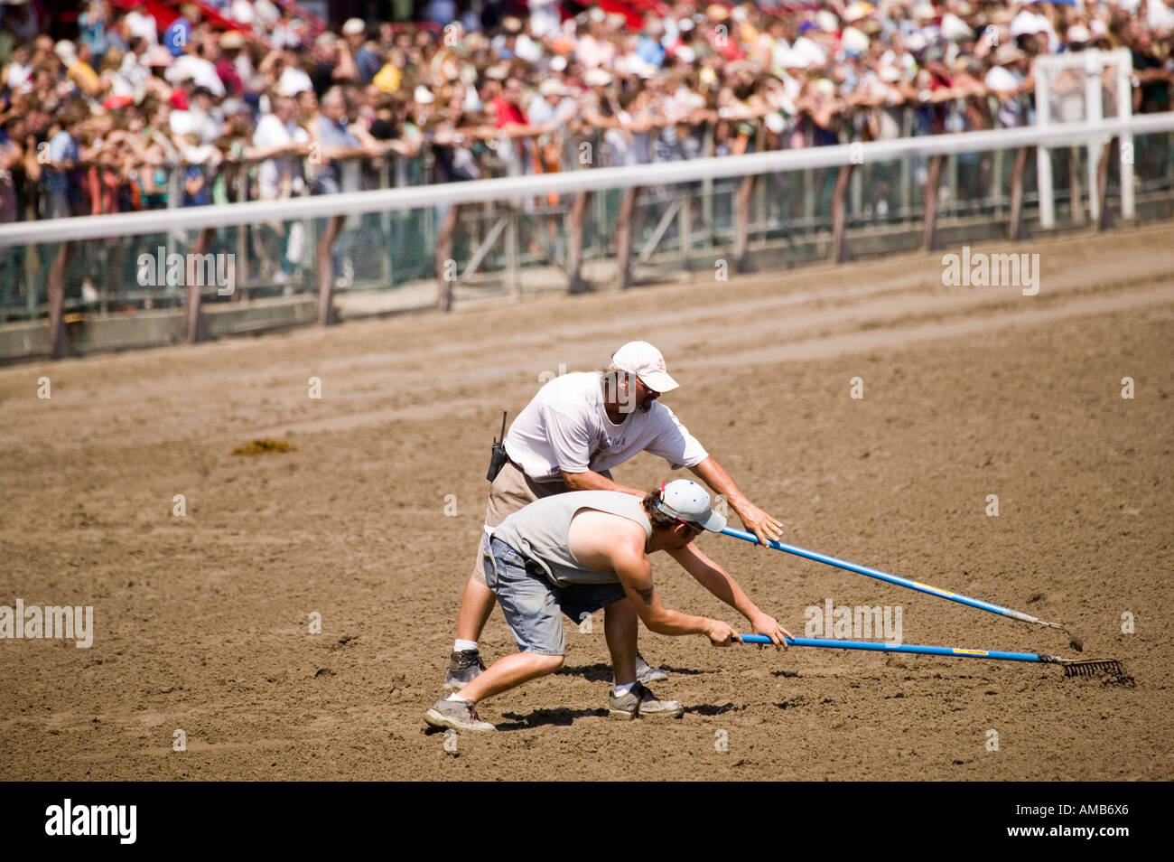 Workers rake the track after the passage of the horses at the Saratoga
