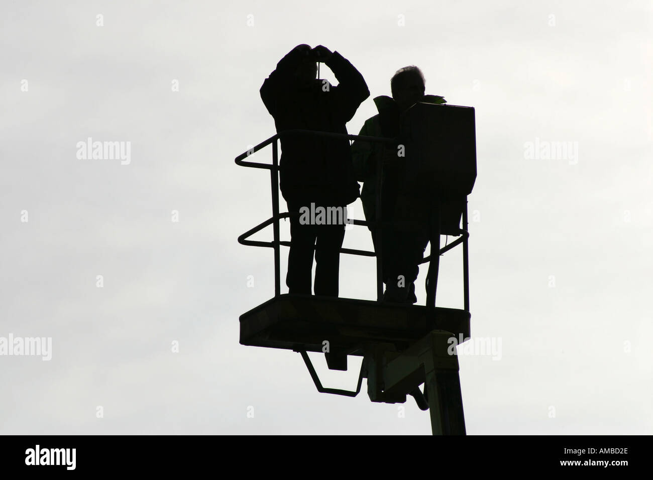 Men in cherry picker carrying out line of sight survey for