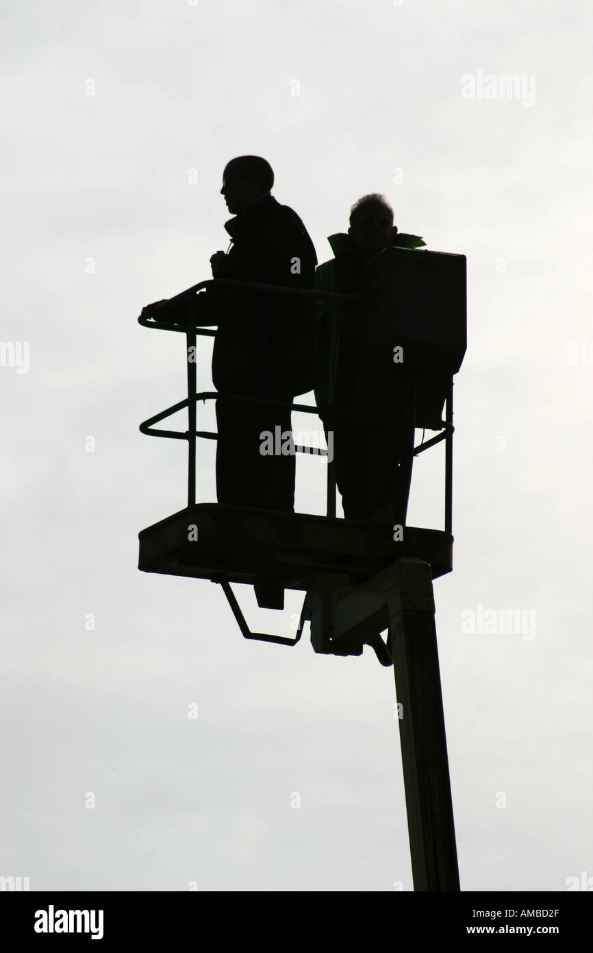 Men in cherry picker carrying out line of sight survey for