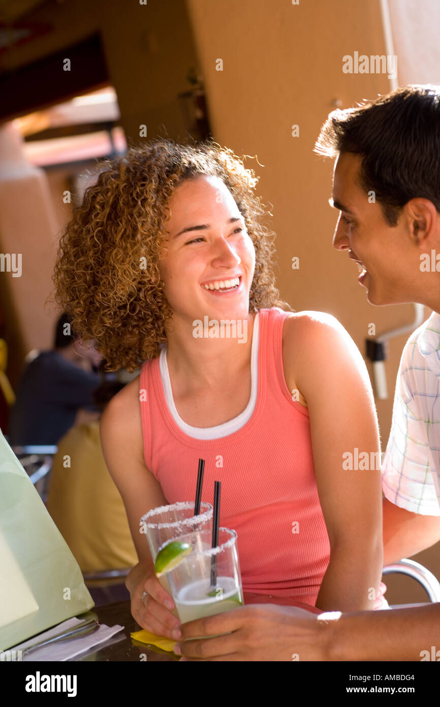 young couple having drinks at outdoor cafe Stock Photo