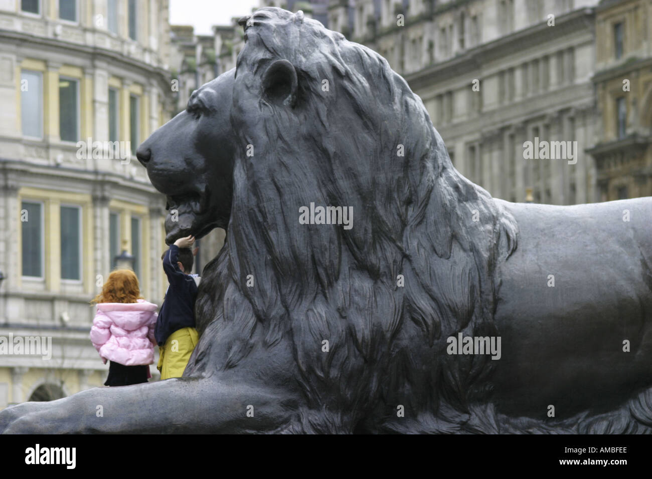 Children Playing on Lion at Trafalgar Square London England Stock Photo