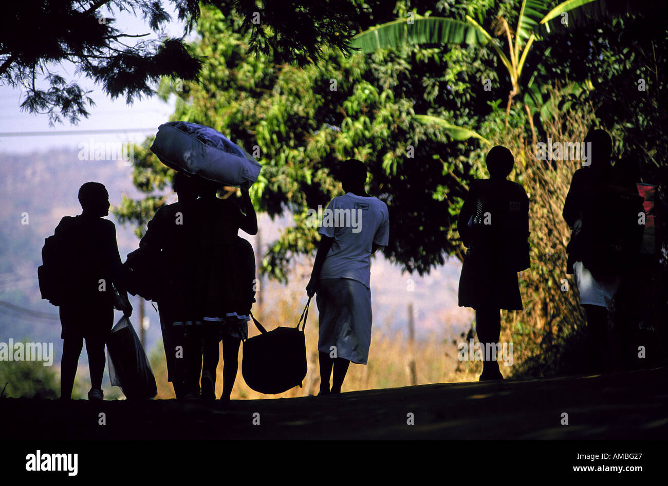 Girls leave on the first day with their bags packed and making their way to Lombamba Stock Photo