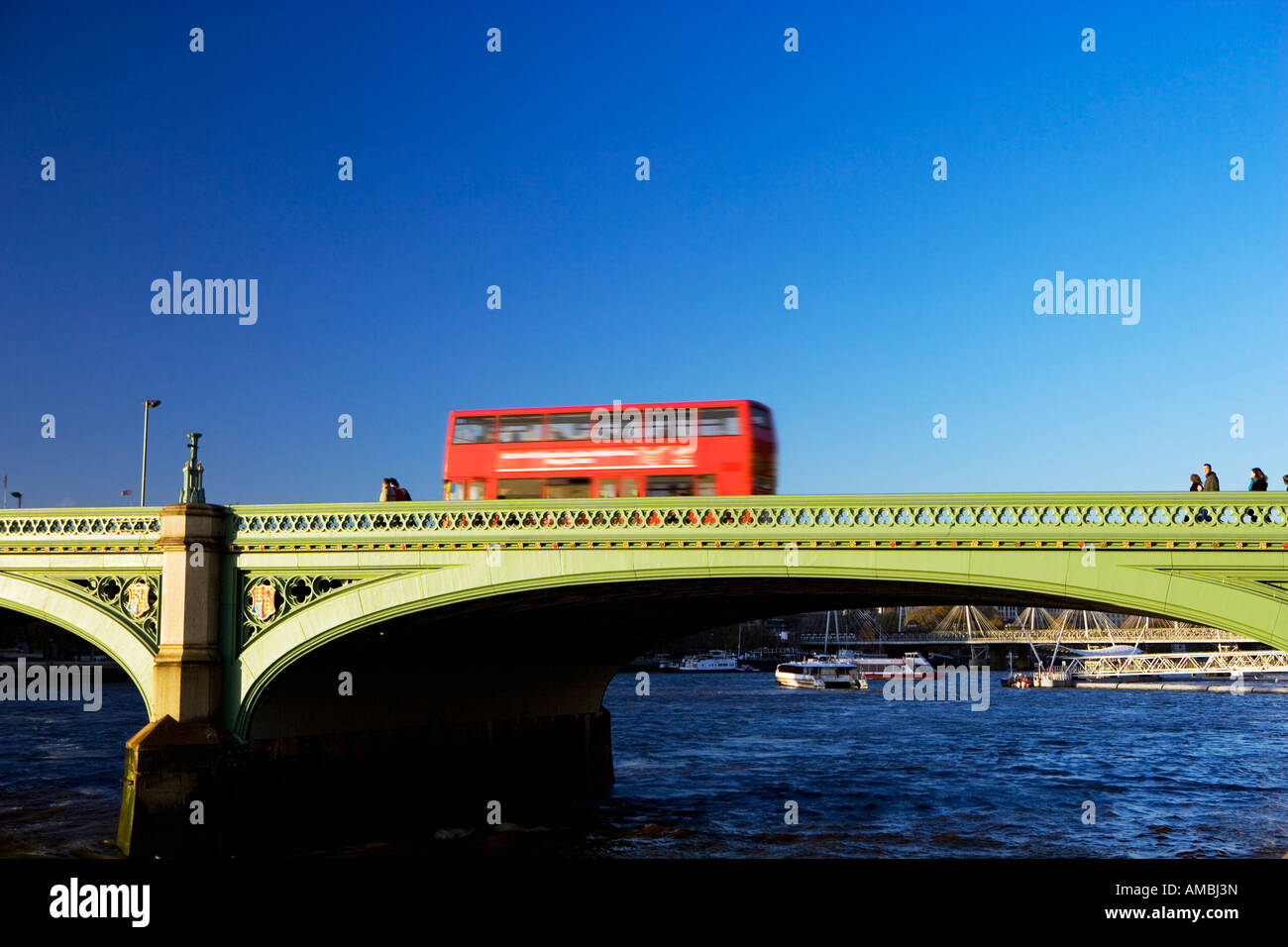 Red London bus going over Westminster Bridge London England Stock Photo