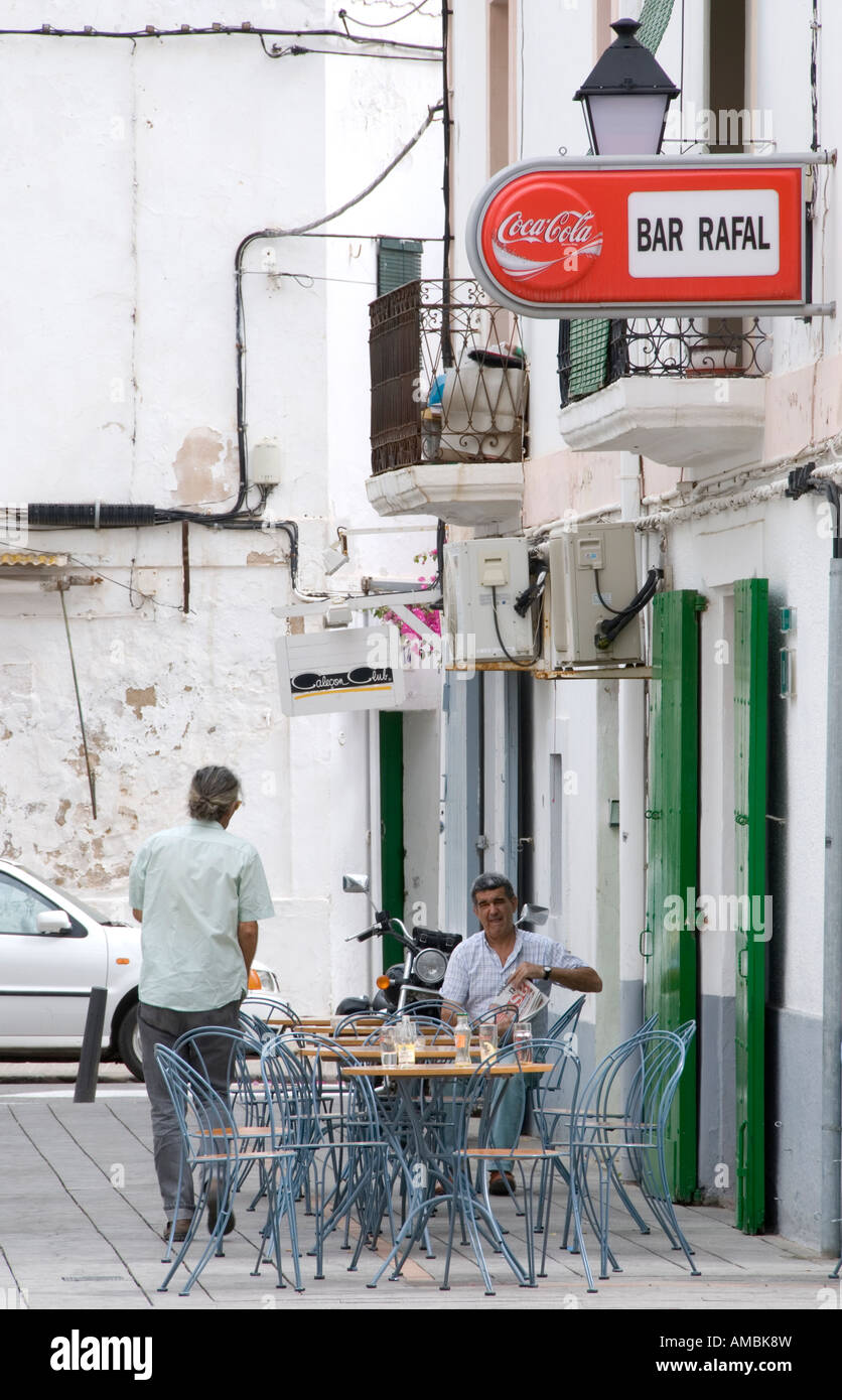 Spanish man sitting outside a traditional bar in the town of Ibiza Stock Photo