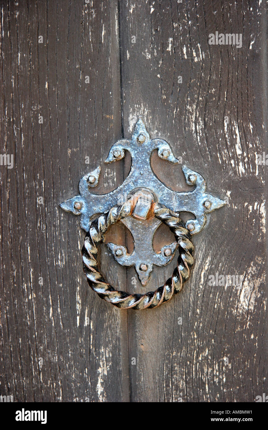 Knobs and knockers plated ring as aturning handle on old wooden church door. Stock Photo