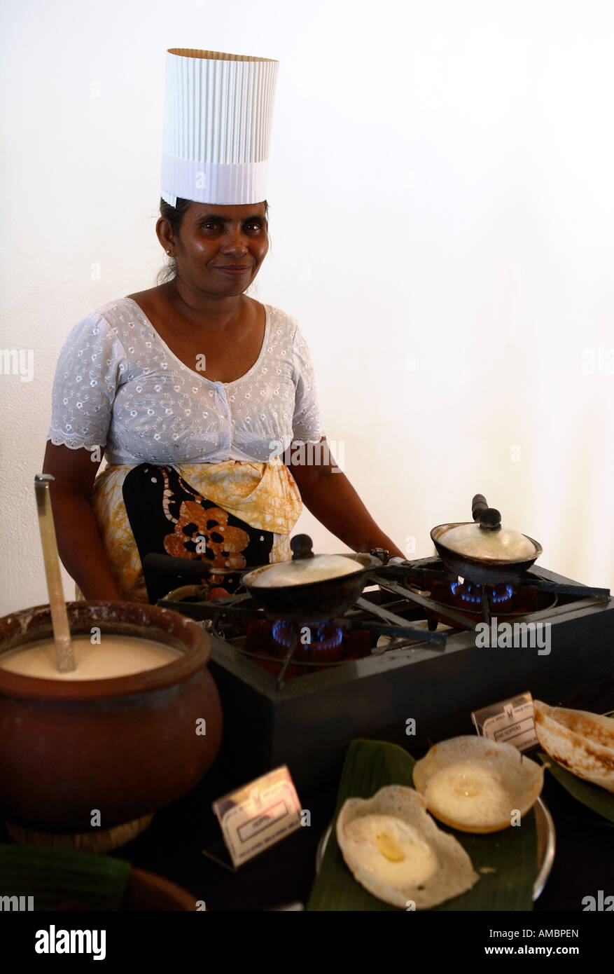 A chef in a Sri Lankan hotel making egg hoppers a crepe shell with an