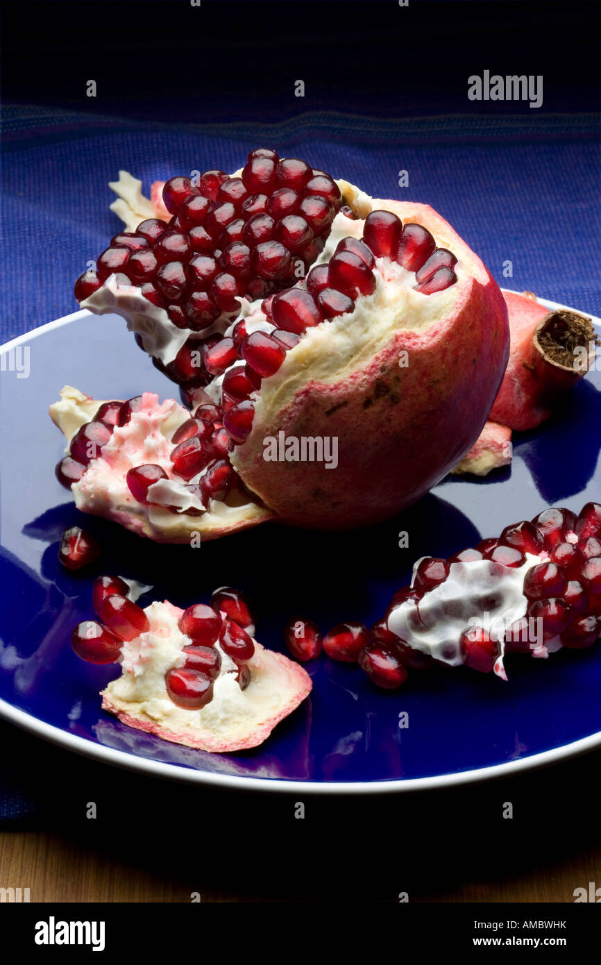 pomegranate on blue plate V Stock Photo
