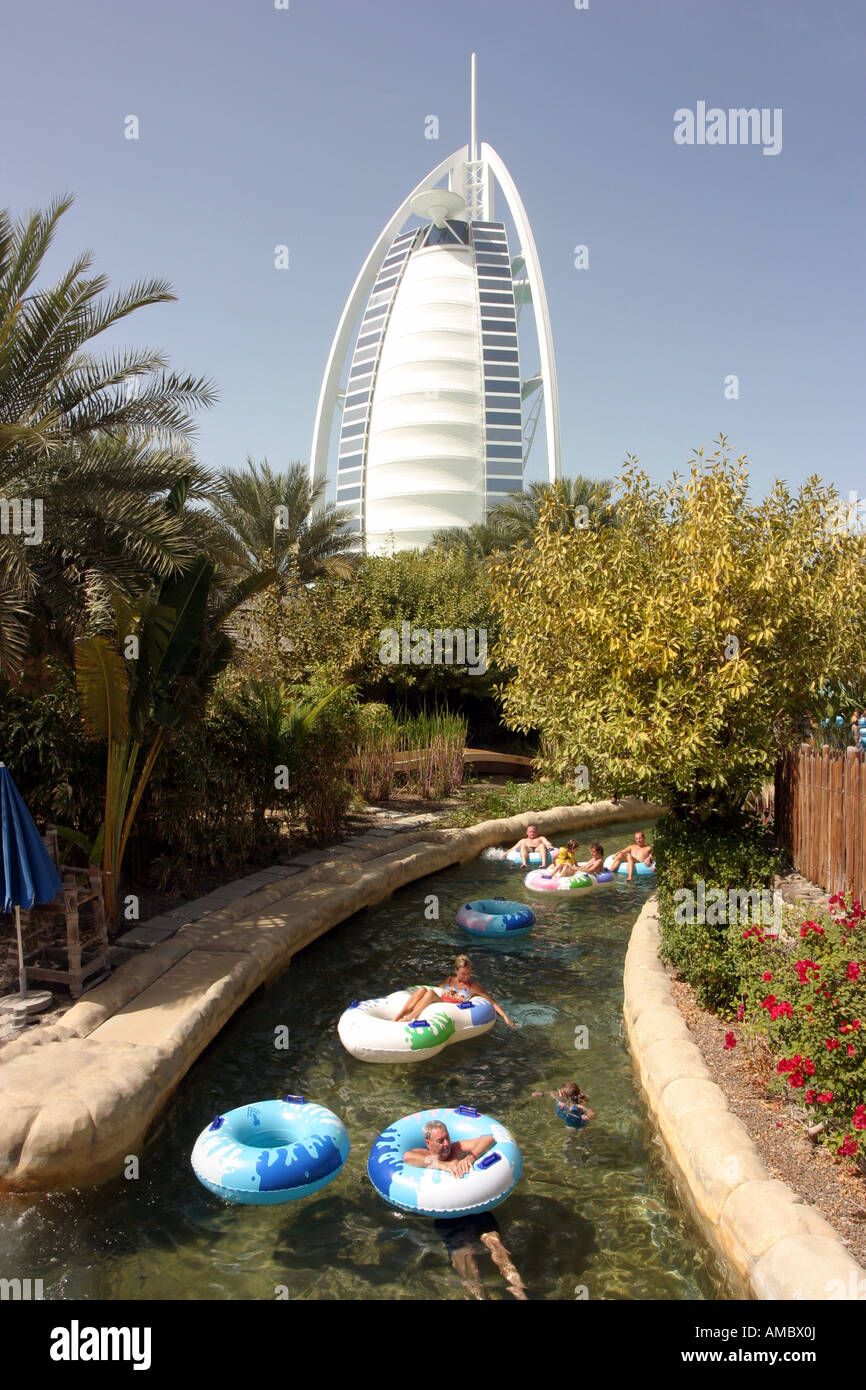Tourists on a water ride with the Burj hotel in the background, Wild Wadi water park, Dubai, UAE Stock Photo