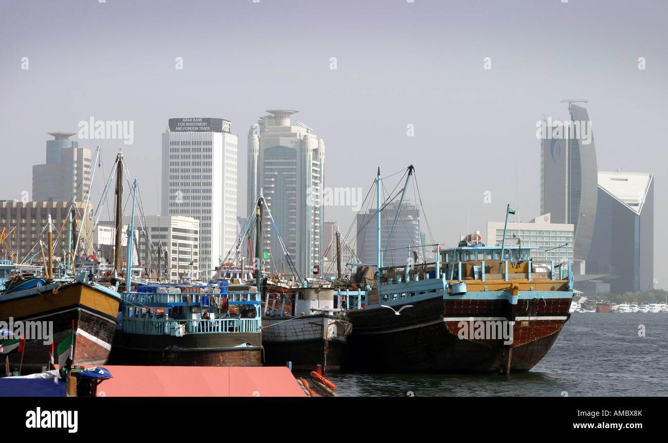 Dhows moored in front of modern skyscrapers, Dubai, UAE Stock Photo